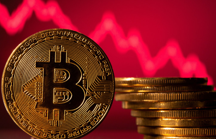 Una rappresentazione di bitcoin è vista davanti a un grafico azionario in questa illustrazione